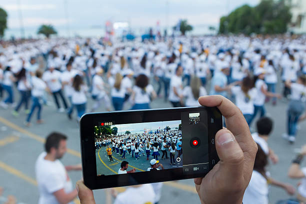 Thessaloniki breaks the Guinness World Record with 1102 people Thessaloniki, Greece - June 1, 2014: Rueda de casino flash mob, particular type of Salsa held in Thessaloniki in order to break the Guinness World Record. 1102 people danced in Aristotelous square. Focus on phone 2014 stock pictures, royalty-free photos & images