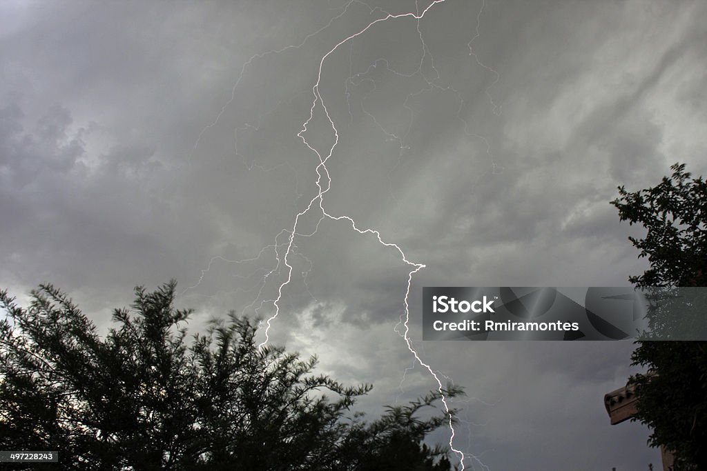 Forked lightning intertwined Summer thunderstorm over Desert Hot Springs CA California Stock Photo