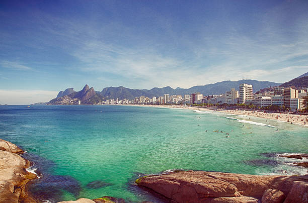 Rio de Janeiro, Brasil – August, 22, 2014: Couple walkin on Ipanema´s sunshine