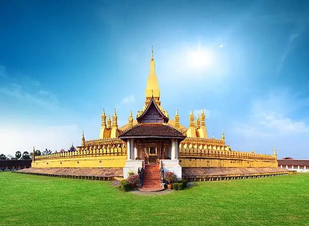 Laos travel landmark, golden pagoda wat Phra That Luang in Vientiane. Buddhist temple. Famous tourist destination in Asia