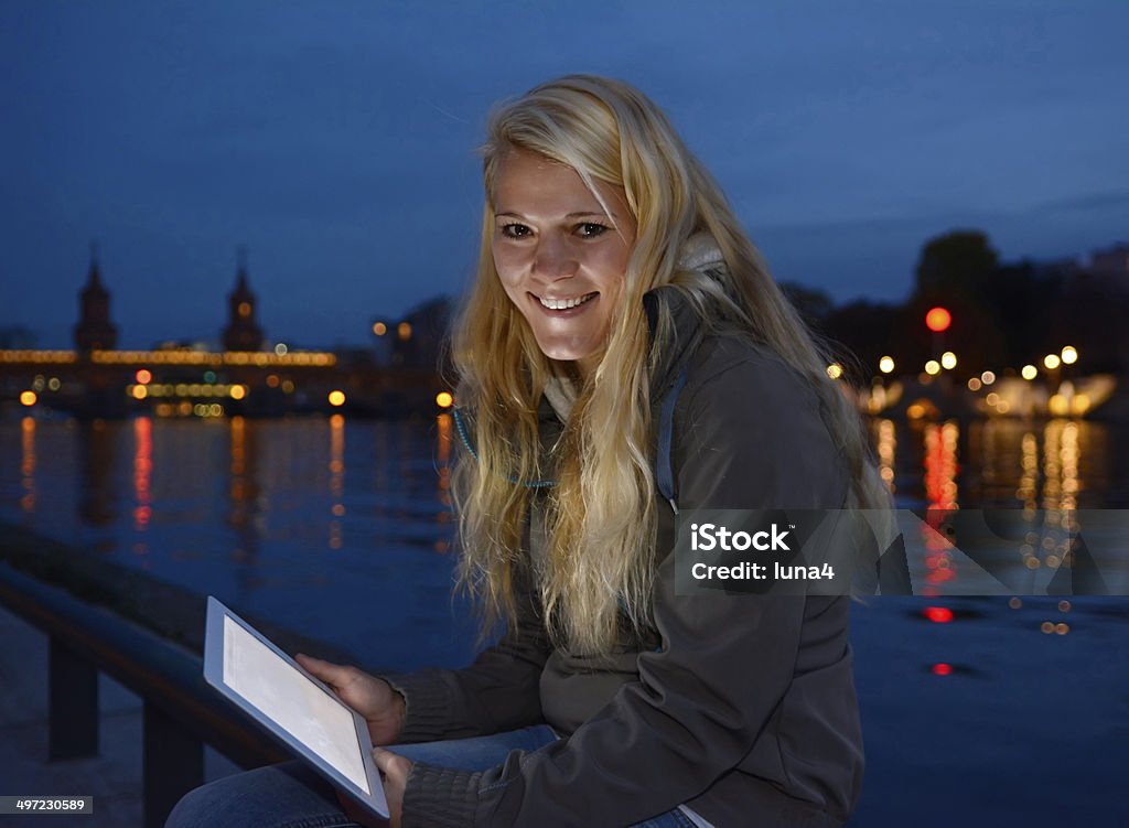 woman with tablet pc at night pretty young blond woman with tablet computer in the city at night Adolescence Stock Photo