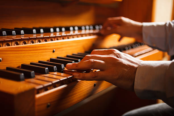 Man playing a church organ stock photo