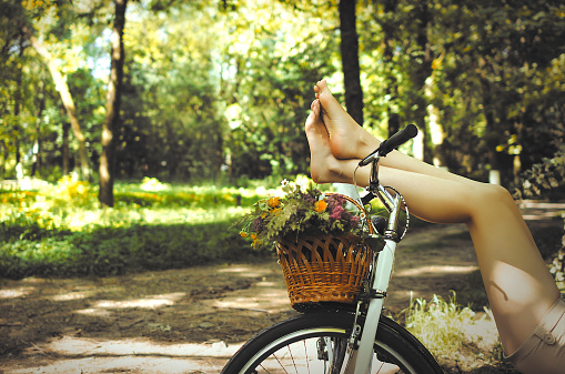 Legs of a beautiful woman on a bicycle