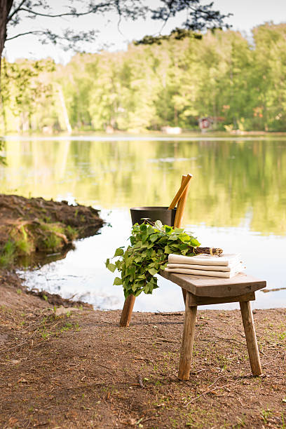 istock Finnish summer landscape and sauna objects on bench by lake. 497232615
