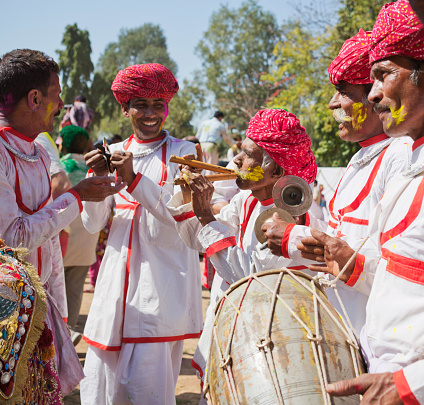 Jaipur, India - March 17, 2014: Local indian men in traditional clothes playing algoze, drum, tingsha during the Holi festival which is a spring festival also known as the festival of colours and the festival of love. Algoze is a pair of Punjabi woodwind instruments adopted by Sindhi, Rajasthani and Baloch folk musicians.