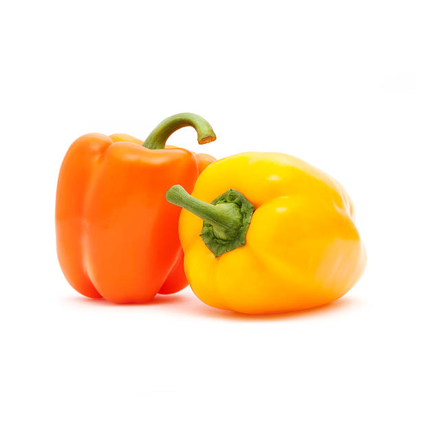 istock Orange and yellow pepper isolated on white background 497233127