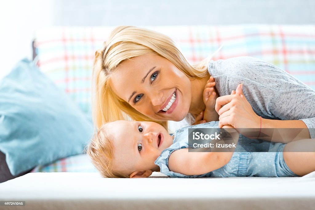 Mother with her baby Indoors portrait of happy mother with her cute baby.  6-11 Months Stock Photo