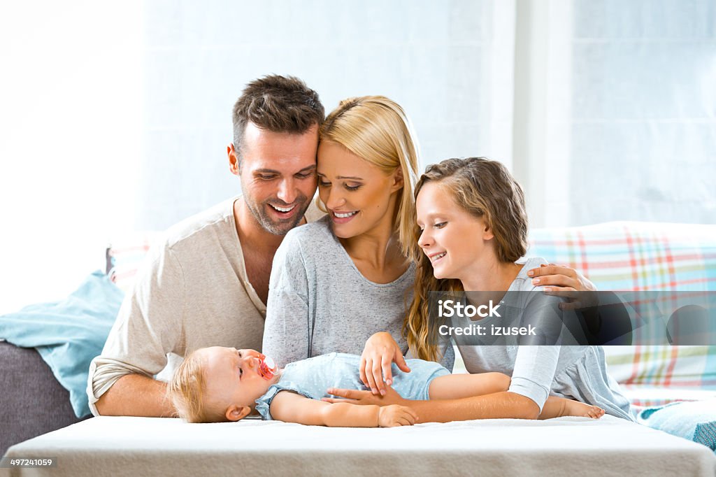Happy family Indoors portrait of happy parents with their children.  6-11 Months Stock Photo
