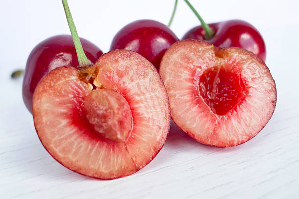 Ripened cherries, red pulp. Group of cherries in studio over white background. hazel tree stock pictures, royalty-free photos & images