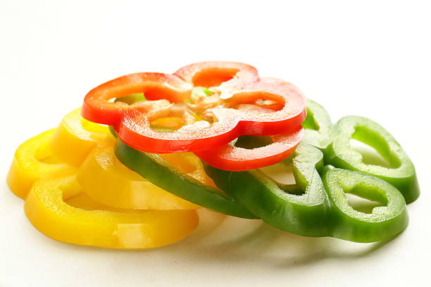 istock red, yellow and green bell pepper sliced ​​on white background 497242243