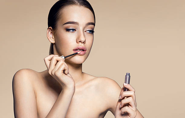 istock Tempting young woman with lip gloss 497248916