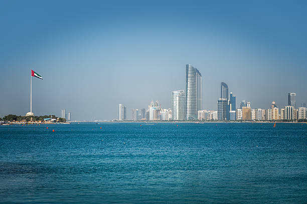 istock Abu Dhabi national flag and skyscrapers 497249092