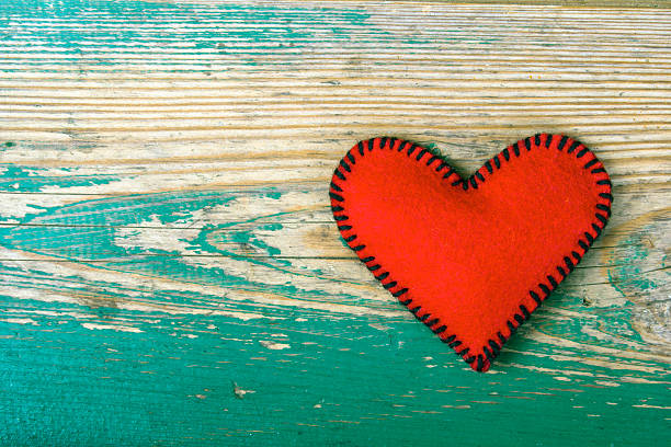 istock red heart on the green planks 497250138