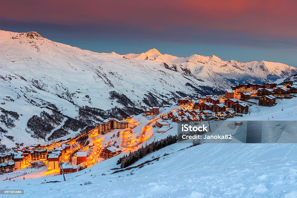 Amazing sunrise and ski resort in the French Alps,Europe Majestic winter sunrise landscape and ski resort with typical alpine wooden houses in French Alps,Les Menuires,3 Vallees,France,Europe 2015 Stock Photo