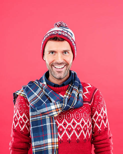 homme heureux en tenue d'hiver sur fond rouge - men sweater excitement satisfaction photos et images de collection