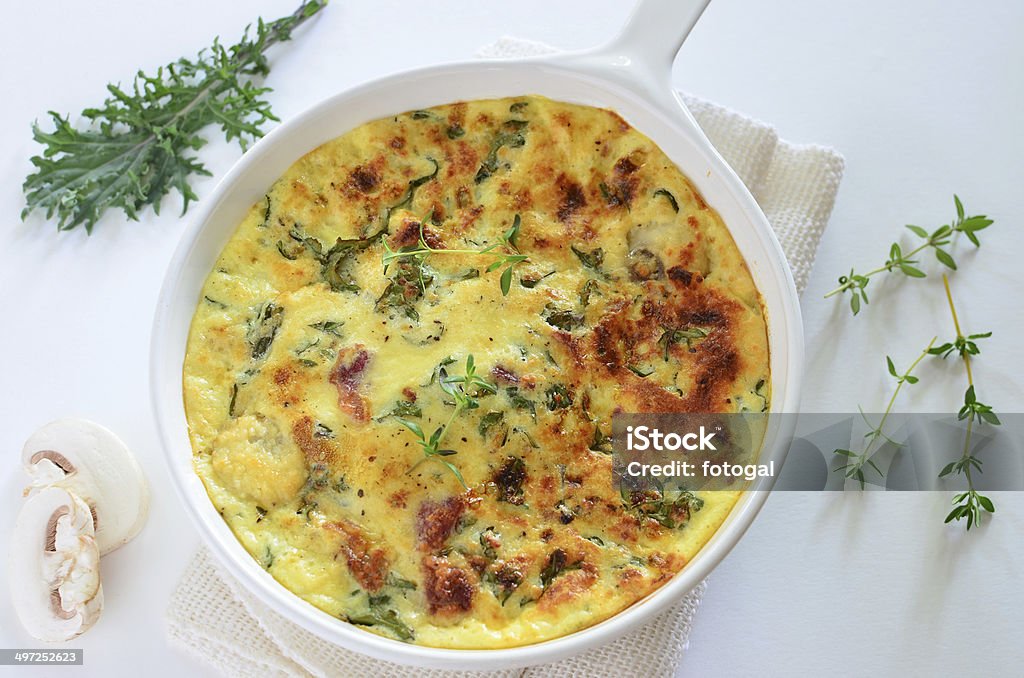 Kale and bacon frittata Healthy kale and bacon frittata with mushrooms and thyme makes a light lunch or dinner Frittata Stock Photo