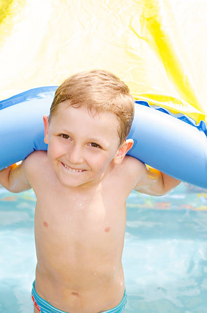 istock cheerful little boy in the pool 497252629