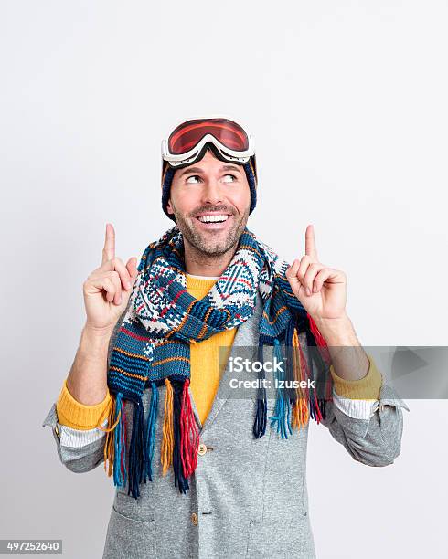 Happy Handsome Man In Winter Outfit Pointing At Copy Space Stock Photo - Download Image Now