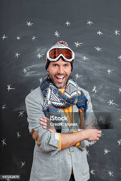 Excited Man In Winter Outfit Against Blackboard Stock Photo - Download Image Now - 2015, Adult, Adults Only