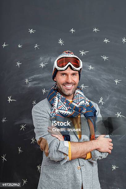 Happy Man In Winter Outfit Against Blackboard Stock Photo - Download Image Now - Arms Crossed, Men, Skiing