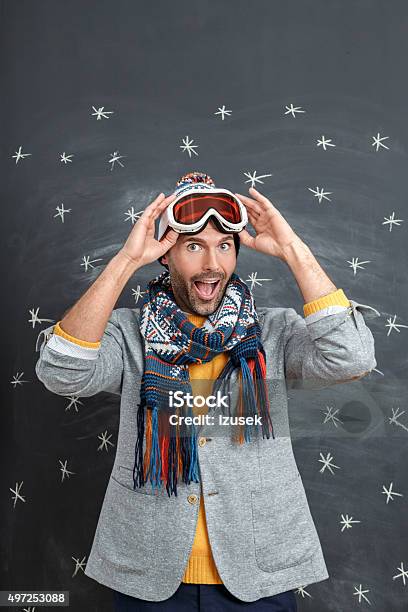 Excited Man In Winter Outfit Against Blackboard Stock Photo - Download Image Now - 2015, Adult, Adults Only