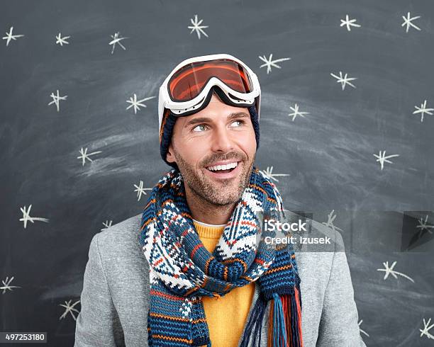 Happy Man In Winter Outfit Against Blackboard Stock Photo - Download Image Now - 2015, Adult, Adults Only