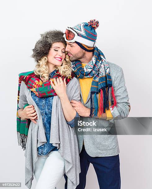 Affectionate Couple In Winter Outfit Against White Background Stock Photo - Download Image Now