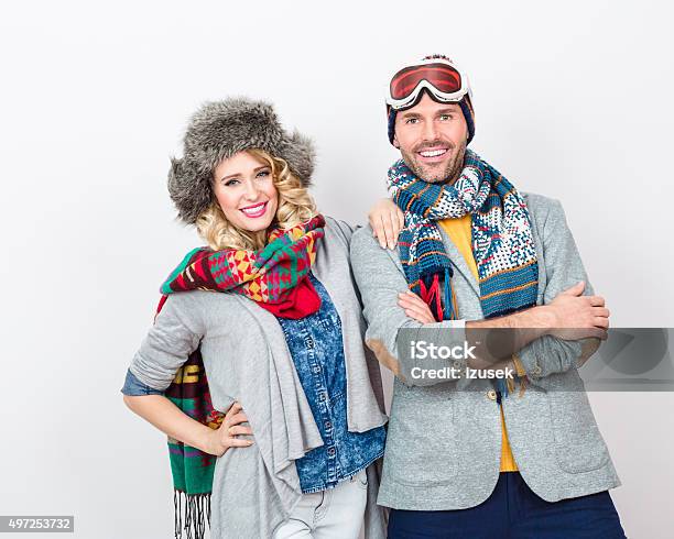 Fashionable Cheerful Couple In Winter Outfit Against White Background Stock Photo - Download Image Now