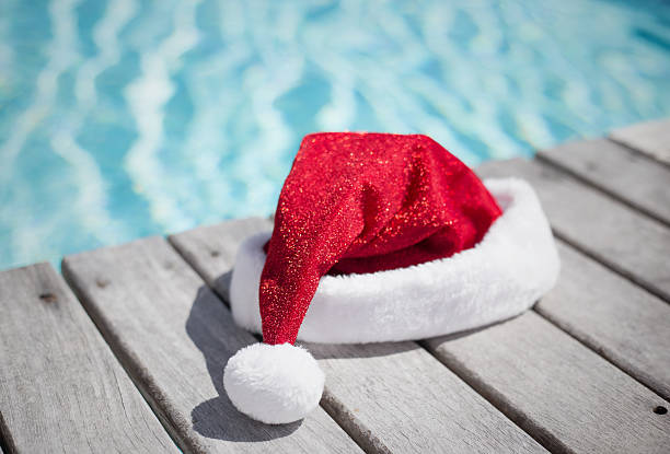 istock Santa hat by the swimming pool 497253862