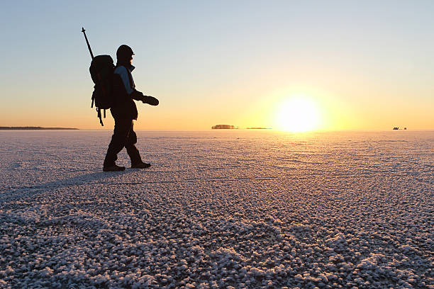 istock The backpacker going on ice on the river at sunset 497254424