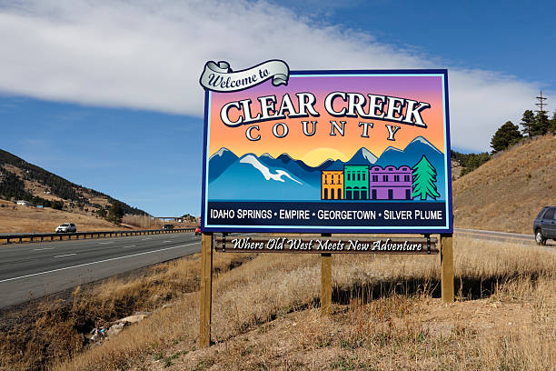 Residential neighborhood street with sign for Rifle creek in historic city during summer in Garfield County, Colorado