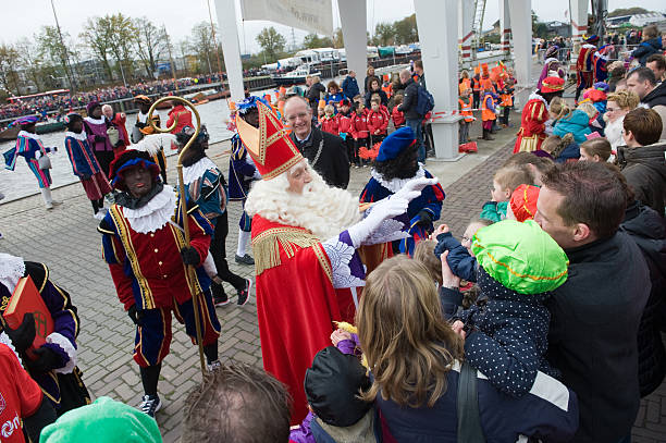 Sinterklaas greeting the children Enschede, The Netherlands - Nov 14, 2015: The dutch Santa Claus called 'Sinterklaas' is arriving with his help Black Pete on a steamboat in a harbor in Holland.  zwarte piet stock pictures, royalty-free photos & images