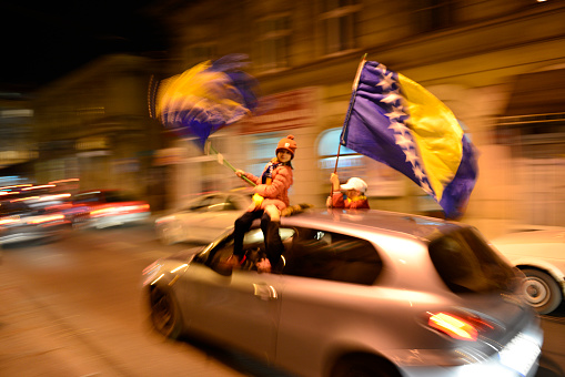 Sarajevo, Bosnia and Herzegovina - October 15, 2013: Children celebrate in downtown Sarajevo after Bosnia's victory in a football match against Lithuania. The win qualified Bosnia for the 2014 FIFA World Cup, the first time the nation would go to the World Cup.