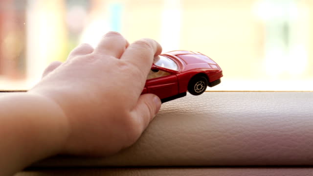 Car toy in baby hand