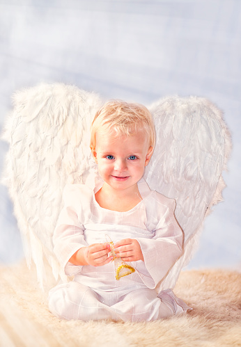 Young blond woman with angel wings