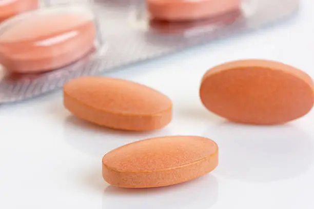 Close up of a Statin tablet - the controversial cholesterol lowering drug.  Shallow d o f