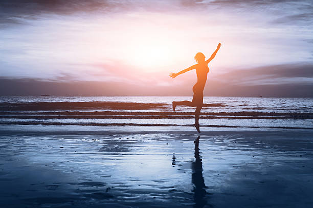 istock carefree woman on the beach 497257572