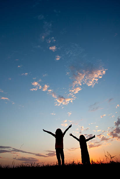 istock Silhouette of Kids Praising God 497258213
