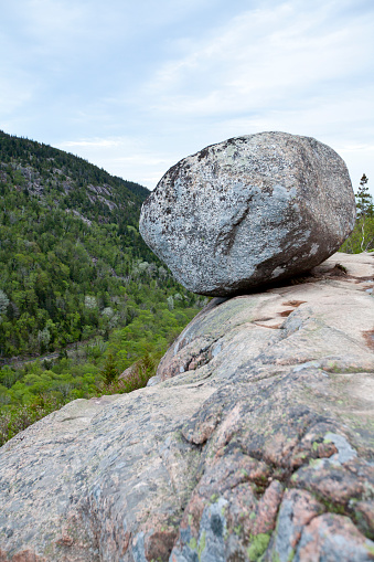 Bubble Rock is arguably the most well-known rock in the entire state of Maine and one of the most visited spots in Acadia National Park. Perched precariously on the eastern edge of the summit of South Bubble, the giant boulder is an excellent example of a glacial erratic, a huge rock that was moved here by the powerful action of ancient glaciers.