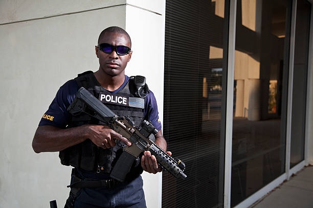 istock Police officer holding rifle 497259977