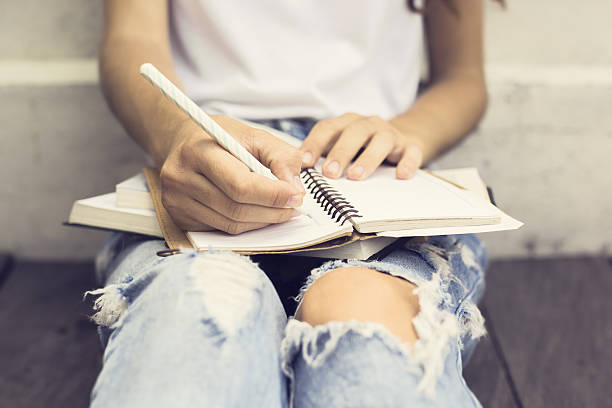 istock Gir with booksl writing in the diary 497260364
