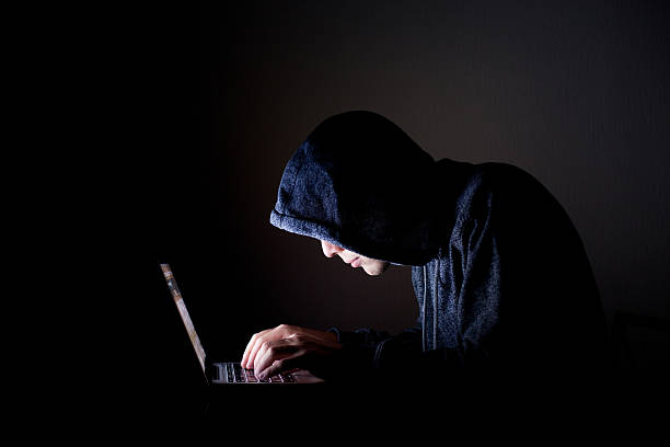 hacker with laptop hacker with laptop, concept pirate criminal stock pictures, royalty-free photos & images