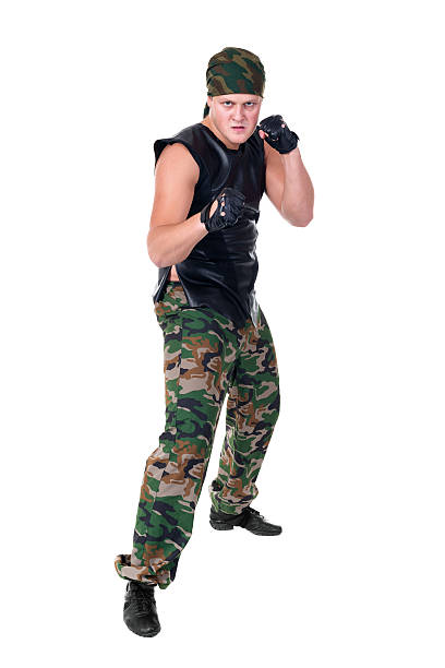 istock Man dressed soldier posing in front fighter isolated on white 497260966