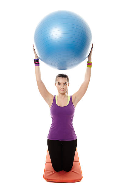 istock Athletic woman holding a ball and doing stretching 497261938