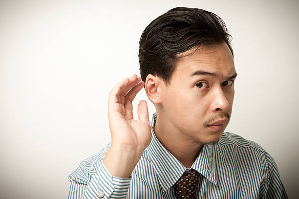istock man try to listening with hand on ear 497262234