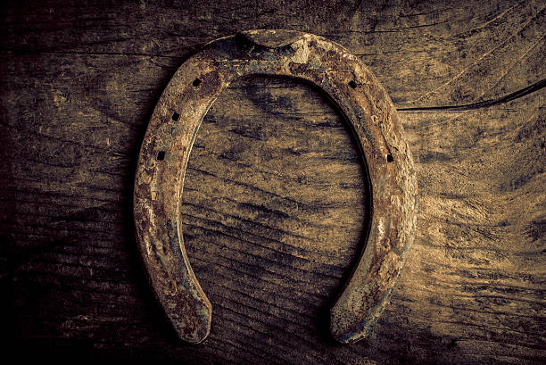 istock horseshoe on old wood background 497262508