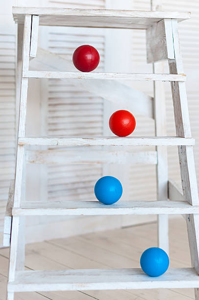 istock Colour plastic balls on wooden stairs for background 497262752