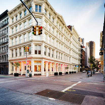 New York City, USA - October 24, 2015: Ralph Lauren store in Soho, Manhattan, photographed  early morning at the corner of Prince and Greene streets. Other luxury stores line Greene street and a few cars are parked down the street. Traffic lights visible.