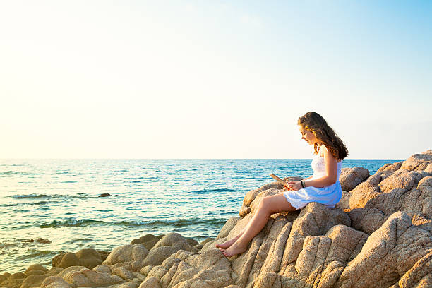 istock Girl on the beach with a tablet 497267175