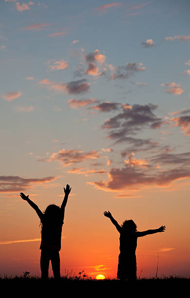 istock Silhouette of Kids Praising God 497268947